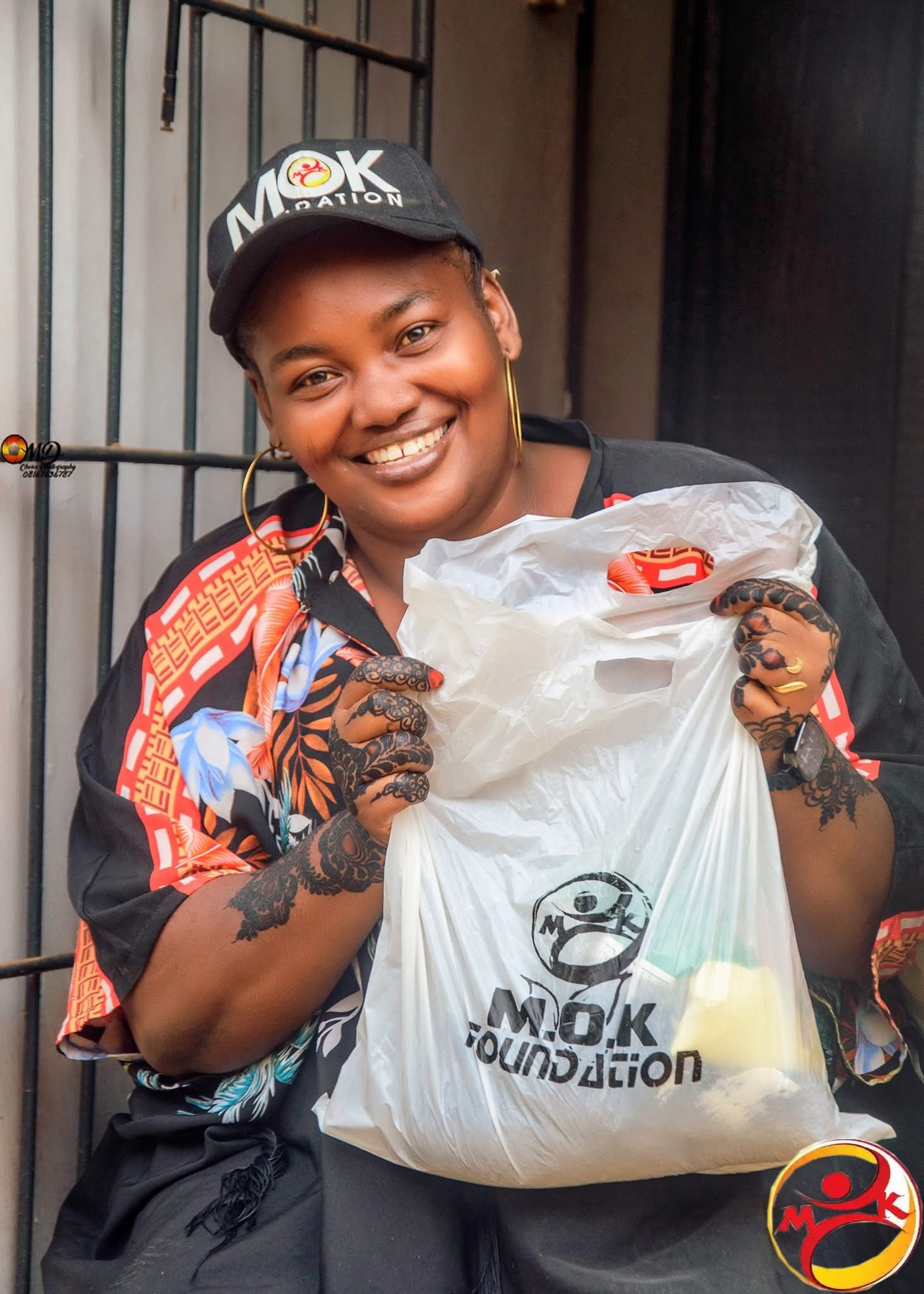 Beneficiary receiving food items from MOK Foundation